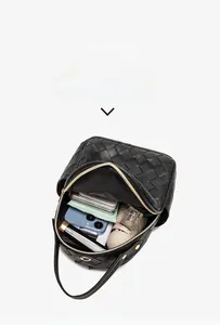 Capacity display of black woven backpack with phone, umbrella, and makeup bag inside