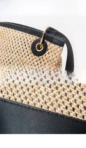 Detail showing high-quality gold hardware ring and reinforced stitching on woven tote bag