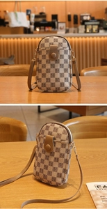 Checkered mini phone bag with leather strap shown in a cozy cafe setting
