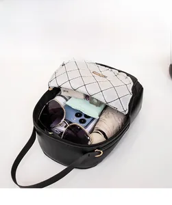 Macro view of the black lychee pattern leather crossbody bag interior showing high capacity