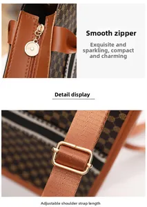 Detail des Metall-Reißverschlusses und verstellbaren Webgurtes an der braunen Shopper-Tasche