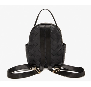 Back view of black woven backpack showing adjustable nylon straps and side pockets