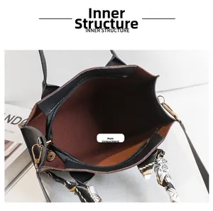 Detail view of printed handbag interior with brown striped lining and zipper closure