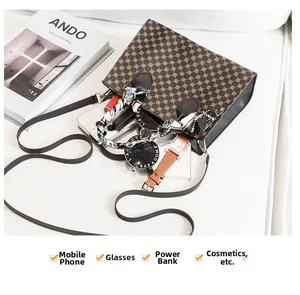 Internal storage detail of brown monogram handbag with phone, lipstick, and sunglasses