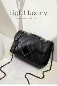 Detail of black quilted chain bag with silver diamond clasp and elegant shadow effect