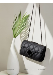 Exquisite black quilted crossbody bag with metal chain strap and elegant geometric buckle