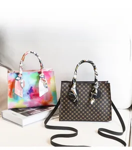 Detail of printed crossbody bags featuring ink-wash patterns and vintage geometric prints