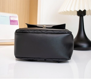 Detail of quilted black PU leather base with gold-tone hardware and rhombus stitching