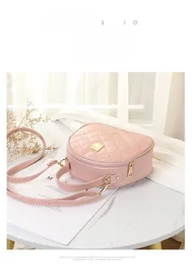 Detail of pink quilted crossbody bag with heart-shaped seams and gold hardware