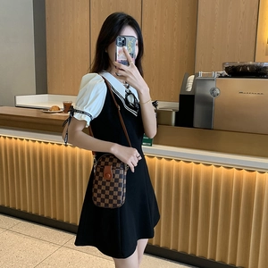Vintage brown checkered vertical crossbody bag shown with an elegant puff sleeve dress