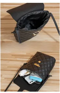 Internal view of black quilted crossbody bag showing spacious storage for phone and essentials