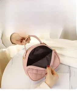 Detailed interior view of pink quilted tote bag showing brown lining and zipper