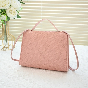 Pink woven texture crossbody handbag with pearl accents and slim shoulder strap