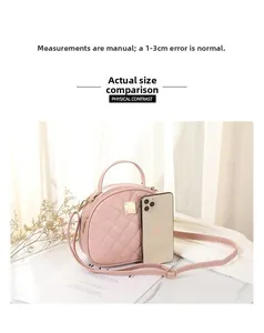 Pink quilted round handbag next to a smartphone showing its compact actual size