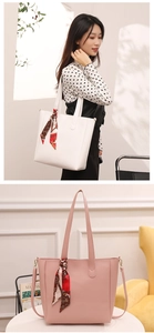 Detail of white and pink large tote bags with decorative scarves and adjustable straps