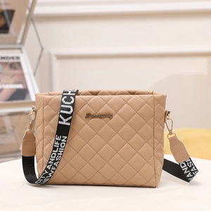 Beige quilted shoulder bag with chic patterned wide strap and metallic logo accent