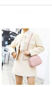 Pink quilted leather crossbody bag on tweed outfit with gold hardware detail