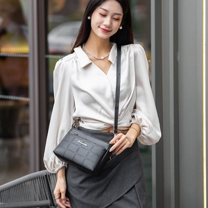 Chic black quilted faux leather crossbody bag for women with an elegant metallic logo