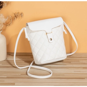 Close-up of white quilted leather crossbody bag with a polished gold metallic buckle