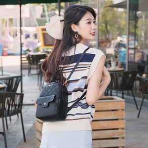 Quilted black leather mini backpack for women featuring adjustable straps and gold metal logo