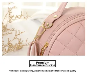 Detail of golden metal hook on pink quilted round bag with electroplated finish