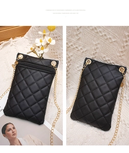 Detail view of black quilted PU leather crossbody phone bag with gold chain strap