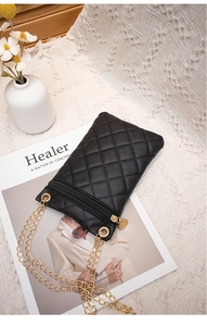 Close-up of black quilted PU leather phone bag with golden chain and zipper detail