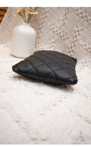 Detailed view of black quilted crossbody bag showing precise stitching and bottom structure