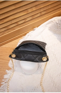 Close-up of the black quilted mini bag interior showing capacity and grey lining texture