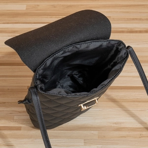 Black quilted cross-body phone bag with metal clasp and interior structure view