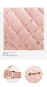 Macro view of light pink quilted PU leather bag with metal logo and adjustable strap buckles