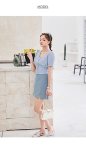 Detail of transparent PVC daisy crossbody bag paired with a blue plaid summer outfit