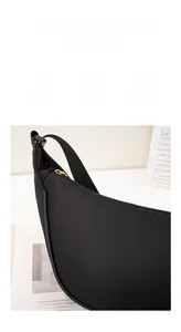 Waterproof nylon crescent bag detail showing durable scratch-resistant texture and gold zipper