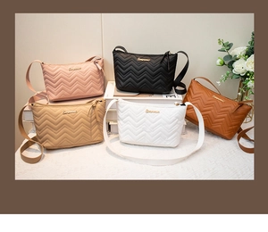 Close-up of multicolor chevron quilted crossbody bags with metal logo and zipper detail