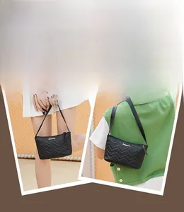 Detail of black chevron quilted small crossbody bag with metal logo and zipper
