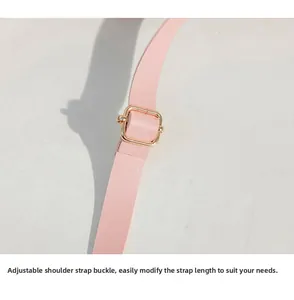 Detailed view of pink PU leather shoulder strap with adjustable golden metal buckle