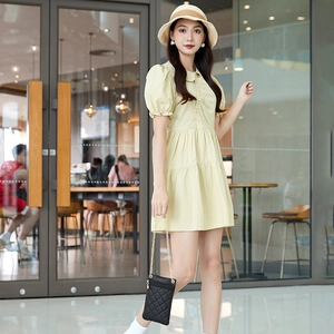 Light yellow puff sleeve mini dress with a pleated skirt and collared front style