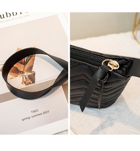 Detail of black V-quilted shoulder bag with gold zipper and leather strap