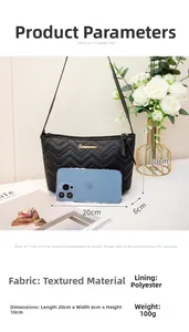 Detail view of black V-quilted underarm bag with gold logo and size chart dimensions