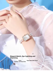 Detail of luxury rectangle watch with mother of pearl dial and pearl bracelet strap