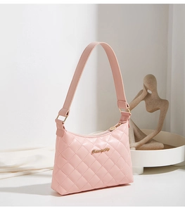 Detailed shot of pink quilted embroidery shoulder bag with gold zipper and logo