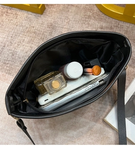 Interior view of the black crossbody bag showing its capacity for phone and cosmetics