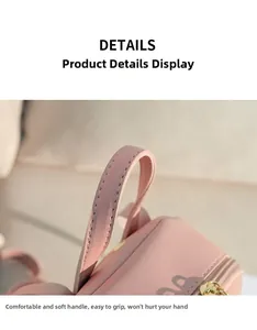 Détail de la poignée en cuir PU rose avec texture grainée et zip doré fluide