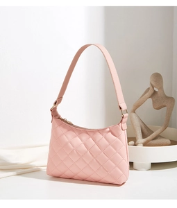 Detail of pink quilted hobo bag with classic rhombic pattern and gold-tone zipper