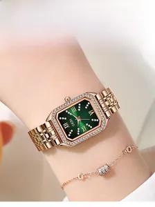 Close-up of luxury green square dial watch with crystal bezel and rose gold strap