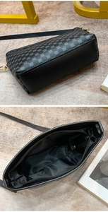 Detail of crossbody bag interior with zipper pocket and patterned synthetic leather base