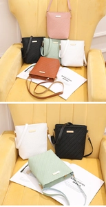 Detail of woven texture bucket bags in pink, black, and green with gold metal accents