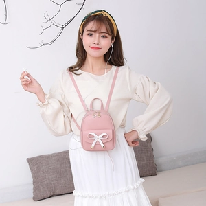 Mini sac à dos rose cerise pour fille avec nœud en cuir blanc et zip doré