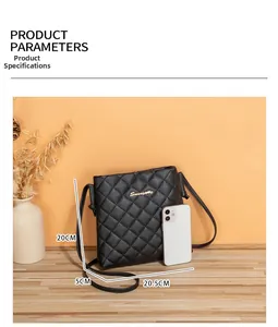 Detailed view of black quilted crossbody bag with gold metal logo and size measurements