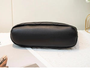 Close-up of the black leather shoulder bag base featuring elegant quilted stitch patterns